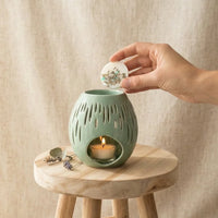 bruleur à fondant galet parfumé en  céramique vert d'eau